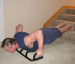 The Atlas push up bar using wide grip on one step